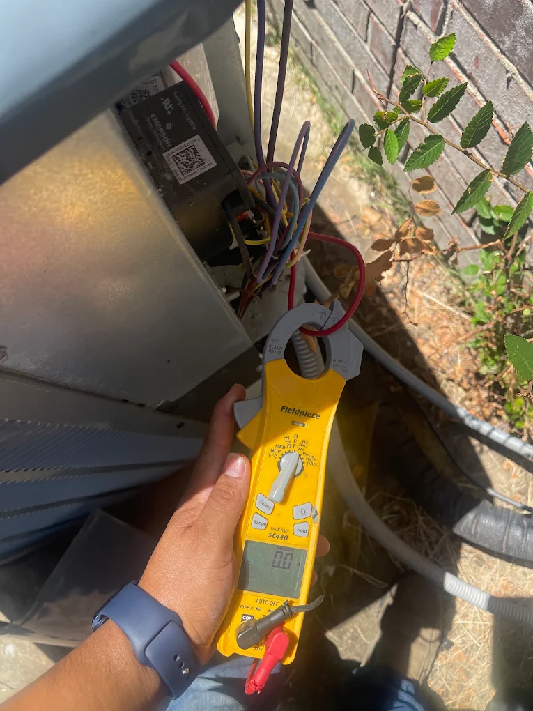 Tito's technician diagnosing an outdoor AC unit